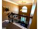 Elegant staircase overlooking the front entry, featuring decorative accents and natural light creating an inviting atmosphere at 80 Tanners Ct, Covington, GA 30016