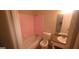 Bathroom featuring a shower-tub combo with pink tile and a granite-look vanity at 3603 Manhattan Dr, Decatur, GA 30034