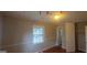 This bedroom features a window, hardwood floors, and a double-door closet at 3603 Manhattan Dr, Decatur, GA 30034