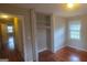 Bedroom with wood floors, window, and an open closet at 3603 Manhattan Dr, Decatur, GA 30034