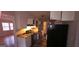 Kitchen with light countertops, white upper cabinets, and black appliances at 3603 Manhattan Dr, Decatur, GA 30034