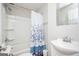 Bathroom with shower/tub combo and floral shower curtain at 8816 Ashwood Dr, Riverdale, GA 30274