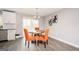 Bright dining area with a round table and orange chairs at 8816 Ashwood Dr, Riverdale, GA 30274