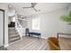 Living room with stairs to upper level and a blue bench at 8816 Ashwood Dr, Riverdale, GA 30274