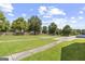 View of a grassy backyard with a wooden fence and concrete pathways at 103 Odyssey Turn, Conyers, GA 30012