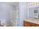 Bathroom with tub, shower, vanity, and wood cabinets at 103 Odyssey Turn, Conyers, GA 30012