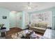 Living room features a neutral colored couch, glass coffee table, and large window at 103 Odyssey Turn, Conyers, GA 30012