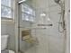 Walk-in shower with tiled walls and bench seat at 6063 Cristie Dr, Ellenwood, GA 30294