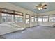 Bright sunroom with multiple windows and ceiling fan at 6063 Cristie Dr, Ellenwood, GA 30294