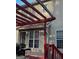 A deck with a red pergola with a view into the backyard at 3722 Lockerbie Ln, Powder Springs, GA 30127
