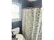 Bathroom with shower/tub combo and patterned curtain at 3722 Lockerbie Ln, Powder Springs, GA 30127