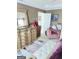A view of the main bedroom highlighting a large dresser, a pink chair, and a white bench at 3722 Lockerbie Ln, Powder Springs, GA 30127