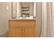Small bathroom features a sink and vanity with a mirror and a patterned shower curtain at 2020 Moore Rd, Moreland, GA 30259