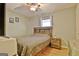 Bright bedroom with a comfortable bed, ceiling fan, wood laminate flooring, and natural light at 2020 Moore Rd, Moreland, GA 30259