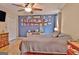 Large bedroom featuring a fan, closet, and an accent wall with framed photos at 2020 Moore Rd, Moreland, GA 30259