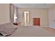 Neutral bedroom featuring light walls, wood floors, and a connecting door to the bathroom at 2020 Moore Rd, Moreland, GA 30259