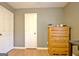 Bedroom featuring wood floors, two closets, and a natural wood dresser at 2020 Moore Rd, Moreland, GA 30259