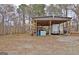 Spacious carport with trailer and room for multiple vehicles at 2020 Moore Rd, Moreland, GA 30259