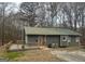 Well-maintained single-story home with a wooden deck, metal roof, and picturesque natural setting at 2020 Moore Rd, Moreland, GA 30259