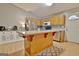 Bright kitchen with a center island, stainless steel appliances, wooden cabinets, and modern fixtures at 2020 Moore Rd, Moreland, GA 30259
