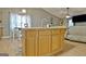 Open kitchen featuring a large island with seating, double sink, wooden cabinets, and an airy atmosphere at 2020 Moore Rd, Moreland, GA 30259