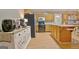 Well-lit kitchen with a central island, wooden cabinets, black appliances, and plenty of counter space at 2020 Moore Rd, Moreland, GA 30259