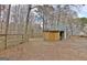 View of the detached storage shed adjacent to the main house with fenced in area at 2020 Moore Rd, Moreland, GA 30259
