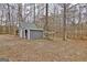 Large shed with ample storage and a covered wood storage area at 2020 Moore Rd, Moreland, GA 30259