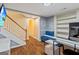 Finished basement area featuring desk, workspace, blue accent wall and sturdy staircase at 232 Terrane Rdg, Peachtree City, GA 30269