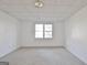 Bright, open basement room with a centered window, neutral carpet, and painted white walls at 232 Terrane Rdg, Peachtree City, GA 30269