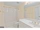 Bright bathroom featuring a shower-tub combo with white fixtures and a vanity with ample counter space at 232 Terrane Rdg, Peachtree City, GA 30269