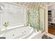 Bright bathroom featuring a garden tub with jets and a separate glass shower at 232 Terrane Rdg, Peachtree City, GA 30269