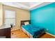 Small bedroom with teal accent wall and hardwood floors at 232 Terrane Rdg, Peachtree City, GA 30269