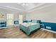 Spacious bedroom with teal accent wall and wood-look floors at 232 Terrane Rdg, Peachtree City, GA 30269