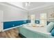 Bright bedroom with teal accent wall and wood-look floors at 232 Terrane Rdg, Peachtree City, GA 30269