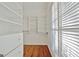 Spacious walk-in closet with white shelving, drawers, and a window providing natural light at 232 Terrane Rdg, Peachtree City, GA 30269