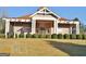 Exterior of community clubhouse featuring a well manicured lawn, beige siding and a covered porch at 232 Terrane Rdg, Peachtree City, GA 30269