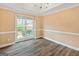 Charming dining room boasts hardwood floors, crown moulding, and natural lighting from a window at 232 Terrane Rdg, Peachtree City, GA 30269