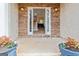 Inviting entryway with stone accents, featuring an open door and planters on either side, welcoming guests at 232 Terrane Rdg, Peachtree City, GA 30269