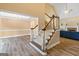 Bright foyer showcases staircase with wood railing and adjacent dining room with chandelier at 232 Terrane Rdg, Peachtree City, GA 30269