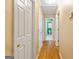 Bright hallway with hardwood floors and access to bathroom and other rooms at 232 Terrane Rdg, Peachtree City, GA 30269