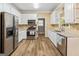 A bright kitchen features stainless steel appliances, white cabinetry and granite countertops at 232 Terrane Rdg, Peachtree City, GA 30269