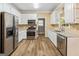 Spacious kitchen featuring stainless steel appliances, granite countertops and wood flooring at 232 Terrane Rdg, Peachtree City, GA 30269