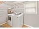 Laundry room with washer, dryer, and ample shelving at 232 Terrane Rdg, Peachtree City, GA 30269