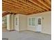 A covered patio with a concrete floor is shown, featuring direct access to the home's interior through a door at 232 Terrane Rdg, Peachtree City, GA 30269