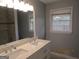 Bathroom with double vanity, large mirror, and shower at 423 Center Sw Cir, Conyers, GA 30094