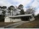 Ranch-style home with carport and mature trees at 423 Center Sw Cir, Conyers, GA 30094
