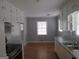 Eat-in kitchen with white cabinets and appliances at 423 Center Sw Cir, Conyers, GA 30094