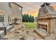 Stone patio with outdoor fireplace and seating area at 115 Haddonstone Dr, Fayetteville, GA 30215