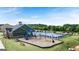 Exterior view of the community pool, clubhouse and playground with trees in the background at 1715 Goodwin Dr # 30, Hampton, GA 30228